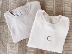 "Embroidered Single Initial Sweatshirt Sweatshirt Colors: Sand, Cream, & White Embroidery: Your SINGLE initial choice Thread Colors: White, Golden Brown, Black, Camel, Beige Sizing of Sweatshirts: Unisex (please see size guides in photos) Placement of embroidery will be centered on the front. Dimensions of embroidery will vary depending on initial, height of initial will be about 1.25\". SAND & CREAM Sweatshirt Details: 8 oz., pre-shrunk 50/50 cotton/polyester WHITE Sweatshirt Details: 8 oz., 50 Custom Embroidery Loungewear Tops, Custom Embroidered Relaxed Fit Tops For Loungewear, Relaxed Fit Tops With Custom Embroidery For Loungewear, Crew Neck Tops With Letter Embroidery For Loungewear, White Custom Embroidered Tops For Loungewear, Cream Tops With Letter Embroidery For Fall, White Monogram Crew Neck Top, Cream Cotton Tops With Letter Embroidery, Cream Cotton Top With Letter Embroidery