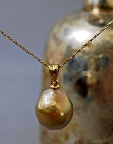 "Hera - Stunning one of a kind very rare freshwater pearl pendant, huge 17mm x 14.5mm x 14mm natural untreated golden metallic pistachio, set in solid 14kt gold - no plating. FREE SHIPPING WITHIN THE US. #846GFP942 **The Stats: Grade: AAA grade nucleated freshwater pearl. Size:  Huge 17mm x 14.5mm x 14mm size. Shape: Even semi-baroque drop shape. Skin: Smoother than expected slightly rippled skin texture. Color: Very rare natural untreated golden metallic pistachio color. Luster:  Silky high lus Pearl Necklace Designs Unique, Ffxiv Character, Bijoux Art Nouveau, Diamond Choker Necklace, Nouveau Jewelry, Pearl Necklace Designs, June Birthday, Pearl Jewelry Wedding, Minimal Necklace