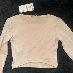 Long Sleeve Zara Top. Ribbed. Very Stretchy. Slightly Cropped. Very Soft Material. Tags Still On Never Worn Beige Stretch Crew Neck Crop Top, Trendy Beige Top With Ribbed Neckline, Zara Stretch Long Sleeve Knit Top, Zara Stretch Knit Top With Long Sleeves, Beige Ribbed Long Sleeve Tops, Beige Stretch Tops With Ribbed Neckline, Zara Ribbed Stretch Knit Top, Trendy Ribbed Beige Top, Trendy Beige Ribbed Top