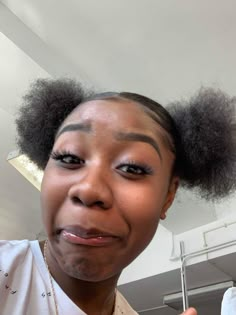 a woman with an afro holding up a toothbrush