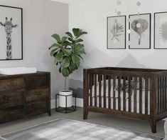 a baby's room with a crib, dresser and pictures on the wall