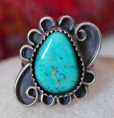 Turquoise Teardrop Ring, Sawtooth Bezel, Framed in Whimsical Scrolls, Sterling Silver. Ring size just under 6. Stone is approximately 6/8th inch long.  Item is in good condition.  This piece is one of many from a collection purchased from a Vermont woman, who traveled to the southwest every winter, for decades. Each trip, she would purchase a piece of silver to remember her time in the desert. Each piece has been cleaned, however, I left plenty of patina!  If you are unsatisfied with your purchase, please contact me within 7 days and return the item within 14 days of purchase for a full refund. I am happy to answer any questions you may have. Teardrop Ring, I Left, In The Desert, The Desert, Vermont, Rings Statement, Statement Rings, Jewelry Rings, Ring Size