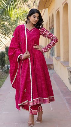 This is a beautiful 3-piece suit set. The set comes with flared anarkali kurta has leheriya print detailing, v neck, full sleeves and calf length teamed with trouser pants and a cotton dupatta to match. The entire set has lace detailing. Total No of Set-3 Kurta Fabric: Cotton Kurta Length - 48 inches Bottom Fabric-Cotton Bottom Fabric - 38 inches Dupatta Fabric: Cotton Dupatta Length - 2.50 meters Work Done on Kurta -Leheriya Print with lace detailing. Sleeve Length: Full Sleeves Front Neck: V Neck Style: Anarkali kurti & palazzo pants Color: Pink Occasion: Party Wear Washing Instructions: Dry Clean Anarkali Set With V-neck And Dupatta, Traditional V-neck Anarkali Set With Dupatta, Anarkali V-neck Sharara For Festive Occasions, Festive Bollywood Anarkali Set With V-neck, Unstitched Traditional Anarkali Set With V-neck, Festive Anarkali Salwar Kameez With V-neck, Designer V-neck Anarkali Set For Diwali, Anarkali V-neck Set For Eid, Designer V-neck Anarkali Set For Navratri