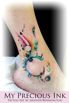 a foot with watercolor tattoos on it and the words, my precious ink tattoo art by amanda remington