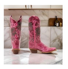 Add a touch of country charm to your wardrobe with the Laredo Women's Paislee Western Boots. These boots feature a stylish snip toe design that adds a touch of sophistication. The pull-on style with pull tabs makes it easy to slip on and off while the 12" shaft height provides a classic western look. The 2.5" western heel adds a subtle lift, and the single-stitch welt construction ensures durability. The solid pink design is elevated by the purple floral overlay, which adds a pop of color and pe Ranch Boots For Spring With Snip Toe, Fitted Boots For Country Events In Spring, Fitted Boots For Spring Country Events, Pink Round Toe Boots For Ranch, Pink Round Toe Ranch Boots, Country Style Boots With Round Toe For Country Events, Fitted Casual Boots For Country Events, Country Style Fitted Snip Toe Boots, Country Style Boots For Ranch In Spring