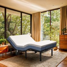 a mattress sitting on top of a wooden floor in front of a sliding glass door