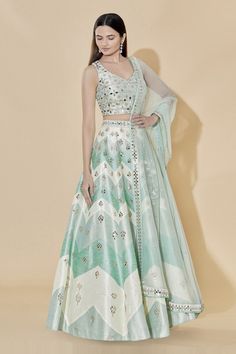 Mint green high-waist lehenga with mirror embellished motifs. Comes with blouse and sheer dupatta.
Components: 3
Fabric: Dupion Raw Silk
Neckline: V neck
Sleeve Length: Sleeveless
Color: Green
Embellishment
Stone and mirror embellished motifs on blouse
Back cutout detail on blouse
Mirror motifs on dupatta
Mirror embellished motifs on dupatta border
Side tassel tie-up detail on lehenga
Closure:
Blouse: Concealed back hook placket
Lehenga: Concealed side zip placket - Aza Fashions Eid Embellished Pista Green Lehenga, Green Embellished Palazzo Set For Wedding, Embellished Green Palazzo Set For Wedding, Embellished Anarkali Sets In Pista Green, Pista Green Embellished Semi-stitched Lehenga, Diwali Embellished Choli In Pista Green, Pista Green Embellished Choli For Navratri, Embellished Pista Green Choli For Navratri, Embellished Pista Green Dupatta For Navratri