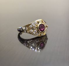 DeKara Designs Collection Metal- 18K Yellow Gold, .750. Stones- 1 Oval Ruby 0.50, 28 Round Diamonds G Color VS2 Clarity 0.22 Carats. Art Deco 18K Yellow Gold Ruby Diamond Engagement Ring. This ring features a beautiful reddish pink ruby that is half carat total weight, surrounded by 28 round diamonds. The center ruby is bezel set, 20 pave set diamonds, and 8 bezel set diamonds. The ring is entirely handmade, and could be hand engraved for an additional $200.00. The ring is a size 6 1/2, and coul Formal Oval Ruby Ring With Single Cut Diamonds, Luxury Yellow Gold Ruby Ring With Single Cut Diamonds, Yellow Gold Ruby Rings With Single Cut Diamonds, Formal Yellow Gold Ruby Ring With Single Cut Diamonds, Ceremonial Oval Diamond Rings, Ceremonial Diamond Gemstone Rings, Luxury Gold Ruby Ring With Single Cut Diamonds, Heirloom Yellow Gold Diamond Ring For Ceremonial Occasions, Gold Ruby Rings With Intricate Design