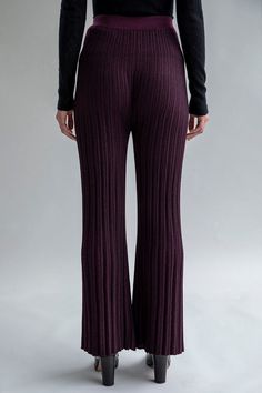 A mid-rise trouser with a flare-leg created from a pleated hem effect, the Marcelle is knitted in a matte and shiny stripe pattern, creating texture interest. Seamless construction reduces the additional fabric on the side seam. Style it with La Vie En Rosettes to create a cinched leg. 54% Polyamide 32% Baby Alpaca 14% Silk Midweight fabric Dry clean only Made in Peru Chic Ribbed Flare Bottoms, Fitted Wide-leg Ribbed Pants, Fitted Ribbed Wide-leg Pants, Elegant Ribbed Pants For Fall, Elegant Stretch Ribbed Pants, Elegant Ribbed Stretch Bottoms, Elegant Ribbed Wide-leg Pants, Elegant Ribbed Straight Pants, Chic Ribbed Elastane Bottoms