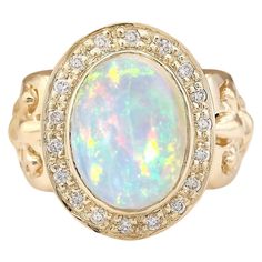 6.40 Carat Natural Opal 14 Karat Yellow Gold Diamond Ring Stamped: 14K Yellow Gold Total Ring Weight: 11.0 Grams Total Natural Opal Weight is 5.90 Carat (Measures: 14.00x10.00 mm) Color: Multicolor Total Natural Diamond Weight is 0.50 Carat Color: F-G, Clarity: VS2-SI1 Face Measures: 20.80x16.65 mm Sku: [704055W] Opal Diamond Ring, Yellow Gold Diamond Ring, La Face, Gold Diamond Ring, Natural Opal, Gold Diamond Rings, Ring Ring, Opal Rings, Cocktail Rings