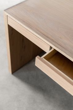 a close up of a wooden table with drawers on it's sides and an open drawer in the middle