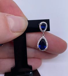 Elegant and timeless blue earrings, in solid 925 silver and shiny, very good quality, a gift idea that will please In 925/000 rhodium silver, they will not change color over time and will not oxidize. To protect this jewel from the natural oxidation of silver, it is covered with a layer of rhodium (a rare and precious metal) which will guarantee its shine over time and prevent the risk of allergy. They are paved with white zirconium oxides and enhanced with sapphire-coloured zirconium. Delivered Blue Drop Earrings, Precious Metal, Blue Earrings, Precious Metals, Good Quality, Made In France, Women's Earrings, 925 Silver, Gifts For Women