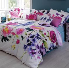 a bed with colorful flowers on it in a room