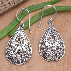 Elaborate silver wirework contrasts with a shimmering dot motif on Kenari's dangle earrings. The Balinese artisan uses sterling silver to create the earrings hand crafting her designs within teardrop frames that dangle from sterling silver hooks. Traditional Teardrop Earrings As A Gift, Traditional Teardrop Earrings For Gift, Bohemian Pierced Teardrop Earrings In Sterling Silver, Traditional Silver Drop Jewelry, Artisan Teardrop Pierced Earrings, Ornate Sterling Silver Teardrop Earrings For Gift, Ornate Sterling Silver Teardrop Earrings As Gift, Ornate Teardrop Earrings As Gift, Traditional Handmade Sterling Silver Teardrop Earrings