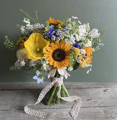 a bouquet of sunflowers, daisies and other flowers