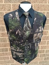 a mannequin wearing a vest and tie with trees on it in front of a brick wall