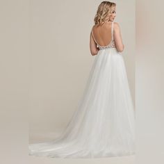 a woman in a white wedding dress looking back