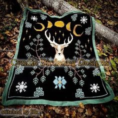 a black and green blanket with an image of a deer's head on it