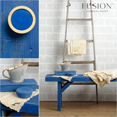 a blue table with some white dishes on it and a ladder in the back ground