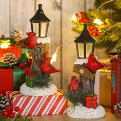 two christmas decorations sitting on top of presents