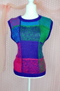 "Cute Vintage 90s Colorful Pullover Sweater Vest..Knit Made. 100% Acrylic. Perfect for Fall/Winter. Wear this with a collar blouse under and with trousers and accessorize. Great vintage condition with no snags or stains. Pre Loved Great Condition Vintage 90s Knit Sweater vest Pullover No Size Label Size approx. Medium Check this measurements below. Shoulder to Shoulder: 18\" Armpit to Armpit: 21\" Waist: 39\" Length: 24\" Shipping from 3-5 Days No Returns or Exchanges Thank you for Visiting" Multicolor Patchwork Top For Winter, Multicolor Knit Patchwork Tops, Retro Purple Winter Tops, Fitted Multicolor Sweater Vest For Fall, Multicolor Knit Crew Neck Sweater Vest, Multicolor Knit Sweater Vest With Crew Neck, Casual Multicolor Sweater Vest For Winter, Retro Color Block Knit Tops, Retro Knit Color Block Tops