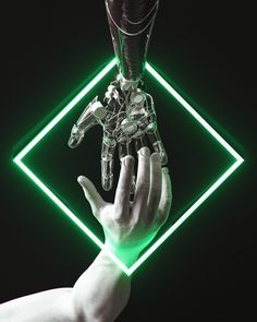 a hand holding a robot in front of a green light