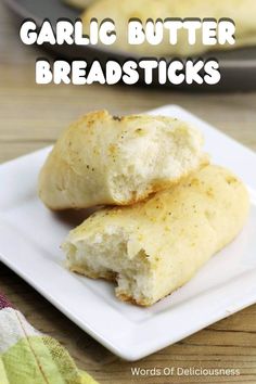 garlic butter breadsticks on a white plate with text overlay that reads garlic butter breadsticks