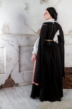 A historical renaissance costume inspired by the Spanish 16-century court and stories of passion in the dark corridors of Escorial palace. The dress was developed based on 16th and 17th-century paintings. With its conical tight corset, wide skirt, and long removable sleeves, as well as dark coloring, the costume bears a distinguishing mark of 16th-17th century Spanish fashion, which has been quite popular in Europe. The costume consists of a skirt, an adjustable corset, a chemise, and a beret. A Regency Style Medieval Dress For Costume Party, Victorian Dress With Historical Design For Costume Party, Victorian Medieval Dress For Cosplay, Medieval Victorian Dress For Costume Party, Medieval Style Victorian Dress For Costume Parties, Medieval Victorian Dress For Costume Party And Festivals, Medieval Style Victorian Dress For Costume Parties And Festivals, Gothic Victorian Dress For Fancy Dress Occasions, Gothic Victorian Dress For Fancy Dress Events