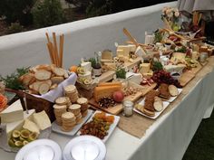 a table topped with lots of cheese and crackers