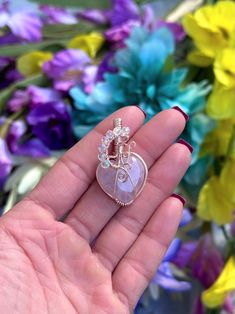 "DESCRIPTION: Wire-wrapped heart-shaped pendant with a rose quartz heart cabochon as the centerpiece and angel aura accent beads. Wires used are 16G, 22G & and 26G rose gold-plated silver (Artistic Wire brand. Pendant size approx. 1\" x 1.5\" and comes strung on an adjustable black cord (pictured)*. NOTE ON MATERIALS: **Please ensure that you do not have allergies to the listed metals. I do not accept returns/all sales are final." Wire Wrapped Jewelry For Valentine's Day Anniversary, Valentine's Day Wire Wrapped Jewelry For Anniversary, Pink Moonstone Jewelry Gift, Wire Wrapped Jewelry For Valentine's Day Gift, Hand Wrapped Heart Pendant Jewelry Gift, Spiritual Heart-shaped Rose Gold Jewelry, Spiritual Rose Gold Heart Jewelry, Heart-shaped Healing Jewelry For Mother's Day, Valentine's Day Wire Wrapped Jewelry Gift