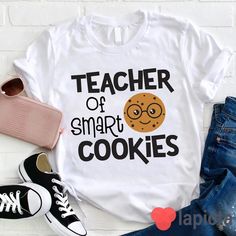 ✔️ TITTLE : Teacher Of Smart Cookies Teacher T-Shirt, Pre-K Shirt, Kindness Matters Shirt, Kindergarten Shirt, Teacher Shirt, Gift For Teacher ✔️ IMPORTANT: Both Men and Women can we our shirts because this is unisex style t-shirts; Wash item inside out in cold water, do not bleach, do not dry clean, do not iron directly on the design. ✔️ MATERIAL DETAILS: 5.3-ounce, 100% cotton (99/1 cotton/poly (Ash) & 90/10 cotton/poly (Sport Grey); Heavyweight classic unisex tee; Taped neck and shoulders; Te Funny White Cotton Shirt, Cute Cotton T-shirt With Name Print, White Cotton Shirt With Funny Style, Funny White T-shirt With Name Print, School T-shirt With Funny Print, Funny Text Print T-shirt For School, Cute Slogan Tops For School, Funny White Tops With Name Print, Casual Tops With Funny Print