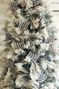 a white christmas tree with black and white bows