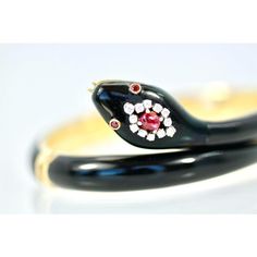 This is part of Chairish’s Fine Jewelry assortment.  Black Enamel Snake Bracelet 18K Ruby Head  This Black Enamel Snake bracelet is in perfect condition. No scratches dents or enamel loss just pristine and gorgeous. This snake is made with 18K yellow gold and it measures 6.5 so it fits a size 6 to a size 7. It weighs 51.8 grams of gold, very substantial. This bracelet has a Ruby head, Ruby eyes and small Diamonds surrounding the large Ruby. The Ruby weighs in at 1/2 of a carat and there are 12 s Designer Enamel Bangle Jewelry, Luxury Enamel Bangle Bracelets, Luxury Collectible Round Bangle, Luxury Yellow Gold Enamel Bangle, Luxury Collectible Yellow Gold Bangle, Elegant Enamel Bangle For Formal Occasions, Luxury Yellow Gold Collectible Bangle, Elegant Formal Enamel Bangle, Elegant Enamel Bangle Bracelets