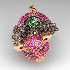 This absolutely wonderful ring features a pig wearing a winged vest in black rhodium. The pig is bead set with two hundred seven (207) round brilliant cut pink sapphires and finished with black rhodium hooves. The eyes are each channel set with one (1) round modified brilliant cut tsavorite. The vest is bead set with seven (7) round modified brilliant cut tsavorites, fourteen (14) round Hue brilliant cut yellow sapphires, ninety-four (94) round brilliant cut Good champagne diamonds and two (2) r Luxury Pink Jewelry Collectible, Luxury Pink Collectible Jewelry, Best Champagne, Flying Pig, Bead Set, Champagne Diamond, Channel Set, Black Rhodium, Yellow Sapphire