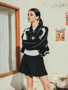 This is varsity jacket that has a feminine and sporty look. With cropped length, pocket details, and ribbed cuff and hem, it is versatile and comfortable to wear daily for a casual outfit. - Color piping detail on the collar- High quality embroidery on the chest- Ribbed cuff and hem- Cropped silhouette Trendy Black Varsity Jacket With Pockets, Black College Style Varsity Jacket With Pockets, Black Casual Varsity Jacket With Pockets, Black Outerwear With Pockets For College, College Style Black Outerwear With Pockets, Sporty Long Sleeve Varsity Jacket With Pockets, Trendy Black Varsity Jacket For Spring, Cropped Long Sleeve Jacket With Ribbed Cuffs For Spring, Spring Cropped Jacket With Ribbed Cuffs And Long Sleeves