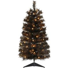 Add a little extra spook to your Halloween with this haunted 3-ft. black tinsel tree from Haunted Hill Farm. This ghostly tree will make an eerie statement in any room its placed in from the moment you unbox it. Black tinsel needles populate each branch and reflect light from every angle. Warm white LED lights are evenly distributed throughout the tree and provide extra light to the frightening display. Metal-hinged branches make it easy to unfold each tier and begin fluffing. These metal branch Spooky Black, Tinsel Tree, Warm White Led Lights, Unique Trees, Halloween Decorations Indoor, Food Storage Containers Organization, Metal Tree, Artificial Tree, White Led Lights