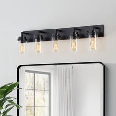 a bathroom vanity light with three bulbs on the side and a mirror in front of it