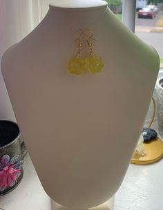 Resin flower shape dangle earrings. These are yellow resin. Hook is gold tone. Very light fun earrings. Please note that with working with resin, bubbles can and may happen. each piece is handmade and unique. Gold Resin Jewelry With Ear Wire, Elegant Resin Earrings With Flower Charm, Yellow Hypoallergenic Flower-shaped Earrings, Resin Dangle Flower Earrings With Flower Charm, Resin Flower Charm Dangle Earrings, Dangle Resin Flower Charm Earrings, Handmade Resin Dangle Flower Earrings, Yellow Resin Dangle Jewelry, Handmade Round Resin Flower Earrings