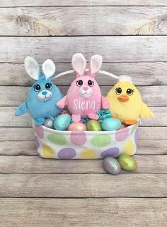 three easter bunnies in a polka dot basket with bunny and chick on the side