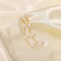 Discover the modern sophistication of Pearl Drop Threader Earrings, elegantly designed in 18k gold plating. These earrings feature a sleek threader design with a lustrous pearl drop, perfect for a refined look. Luxury Linear Teardrop Pearl Drop Earrings, Elegant 14k Yellow Gold Filled Linear Earrings, Pearl Threader Earrings, Tennis Jewelry, Cuff Bangle Bracelet, Moissanite Jewelry, Layered Bracelets, Threader Earrings, Modern Earrings