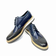 Scarpetto Navy Blue Wingtip Dress Shoes for men are presented in genuine leather. Its lace-up designs characterize the latest collections. With a wingtip and stchiting design, this dress shoe is defined by its unique style and quality. The shoe's refined material and lace-up detail mix with elements taken from the world to create a versatile piece that blends a casual look. Built with genuine leather offers a classy finish and superior stability. A polished genuine leather upper delivers a distinctive everyday look. You can buy this plain shoe for your individual style. You can pair them down to complete a smart formal look. Product Features  Genuine Leather, Fitted with EVA Sole Upper Material: Calf Leather Inner Material: Sheep Leather Sole Material: EVA Shoe Width: Medium(B,M) Heel Heig Blue Lace-up Oxfords For Business, Blue Lace-up Business Dress Shoes, Blue Plain Toe Dress Shoes For Semi-formal, Blue Plain Toe Dress Shoes For Semi-formal Occasions, Designer Wingtip Brogue Lace-up Shoes, Designer Wingtip Dress Shoes For Derby, Designer Wingtip Dress Shoes With Brogue Detailing, Designer Lace-up Wingtip Brogue Shoes, Blue Wingtip Dress Shoes For Business