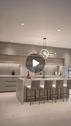 a large kitchen with an island and bar stools