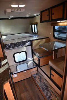 the inside of an rv with wood flooring and counter tops in place for seating