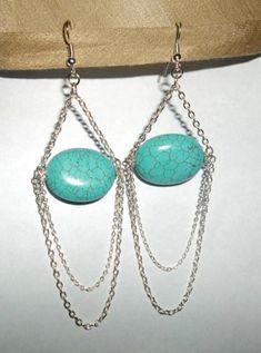 "Great for parties, weddings, career, everyday.   Turquoise is the stone that represent love. These earrings are handcrafted with large  oval turquoise beads and 2 loops of silver plated chains at the bottom  that are different in size.attached to loops at the end of each end of the oval turquoise stone. These earrings hang just under 3.5\" long from the earwire. Free Shipping to US buyer!" Chain Chandelier, Turquoise Chandelier, Silver Chain Earrings, Silver Chains, Beaded Anklets, Feather Earrings, Natural Turquoise, Blue Earrings, Chain Earrings