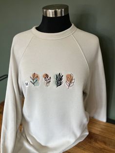 This sweatshirt blends premium quality with a charming design featuring intricate boho-inspired plants (6.8 x 2.4 in), ideal for bohemian style enthusiasts or anyone who loves artistic apparel. If the item is out of stock in the desired size, please reach out and we can provide information regarding time required to restocking. Additionally, if you would like a different color/design, please see our listing for customized orders. Embroidery design file was purchased for license use from ThelabelsCo (more information at https://www.etsy.com/listing/1311340281/commercial-use-license-unlimited-use-for?click_key=633bc425ba2f9250ab277d8c2e26b16662355c10%3A1311340281&click_sum=668e0fd0&ref=shop_home_feat_2). Sweatshirt is of the highest quality, made in America by Bella+Canvas (color: Heather Du Spring Bohemian Cotton Sweatshirt, Bohemian Crew Neck Sweatshirt For Fall, Bohemian Relaxed Fit Sweatshirt For Fall, Botanical Style Cotton Sweatshirt For Fall, Bohemian Cotton Sweater With Relaxed Fit, Bohemian Cotton Sweater Relaxed Fit, Bohemian Cotton Sweater In Relaxed Fit, Bohemian Long Sleeve Sweatshirt With Relaxed Fit, Bohemian Relaxed Fit Cotton Sweater