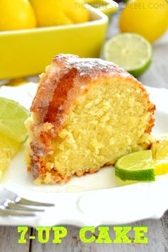 a close up of a piece of cake on a plate with lemons in the background