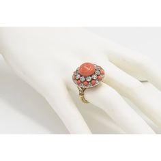 This is part of Chairish’s Fine Jewelry assortment.  Beautifully made art deco style coral ring featuring a button shaped coral centrally surrounded by 11 bezel set  - .20 carat each diamonds which is then surrounded by an alternating smaller diamond and cabochon coral frame.   Each of the ring shoulders have 3 diamond accents.   The bottom of the ring has a highly stylized pierced design. Elegant Coral Rings For Anniversary, Elegant Coral Ring Jewelry, Vintage Coral Jewelry For Anniversary, Coral Vintage Jewelry For Anniversary, Formal Coral Ring, Coral Elegant Wedding Rings, Elegant Coral Wedding Rings, Wide Band Engagement Ring, Oval Sapphire Ring