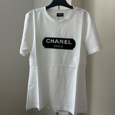 100 Authentic Chanel Uniform T-Shirt Size Xs Brand New White Crew Neck T-shirt With Designer Logo, Designer Graphic Tee With Crew Neck, Designer Logo Graphic Tee With Crew Neck, Graphic Tee With Designer Logo And Crew Neck, Casual Cotton Tops With Designer Logo, Designer Logo Cotton Tops For Summer, Casual Crew Neck Top With Designer Logo, Summer Cotton Tops With Designer Logo, Summer Designer Logo Crew Neck T-shirt