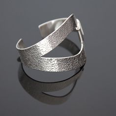 .925 Sterling Silver Fits wrist size 6" to 6 3/4" Handmade using goldsmith techniques Elegant Adjustable Cuff Rings, Polished Wide Band Bracelet For Formal Occasions, Modern Sterling Silver Cuff Jewelry, Unique Open Band Jewelry With Polished Finish, Modern Hand Forged Bangle Bracelet, Adjustable Open Band Bracelet With Polished Finish, Modern Hammered Cuff Jewelry, Adjustable Polished Open Band Bracelet, Elegant Sterling Silver Hammered Bangle