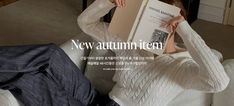 a woman sitting on a couch holding an open book in front of her face with the caption new autumn item